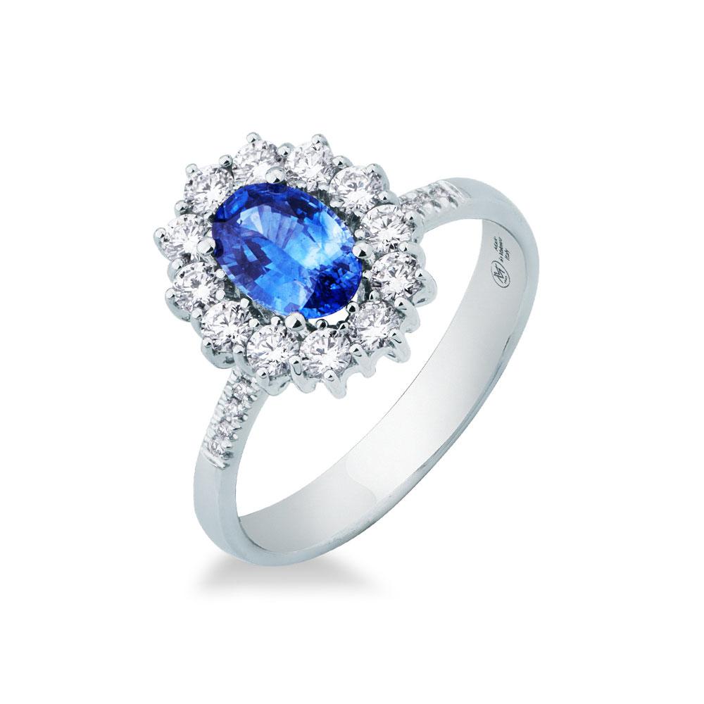 Anello con zaffiro blu e contorno di diamanti, montatura in oro bianco